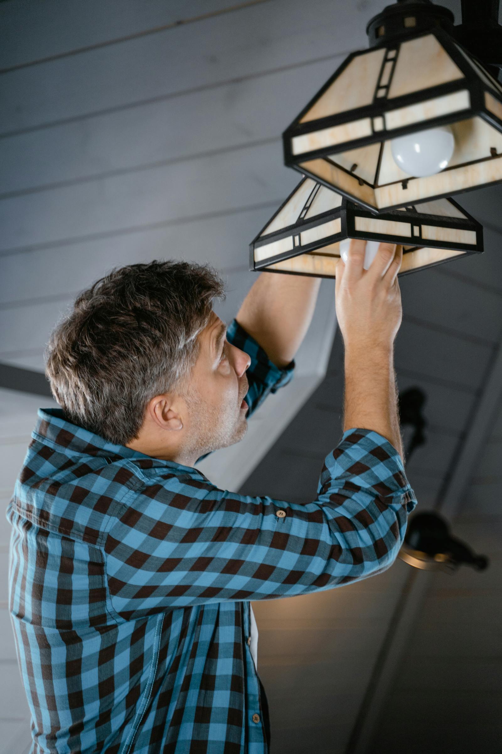 Electrician installing a light fixture